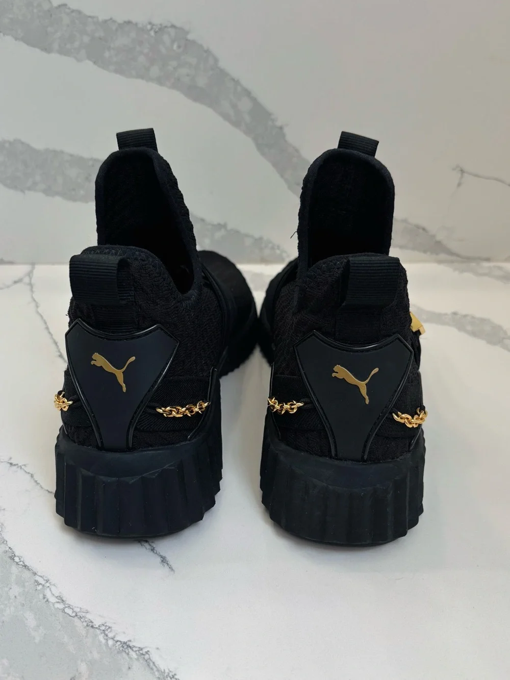 PUMA Women’s 10 Defy Mid Black Training Sneakers with Gold Buckle and Chain